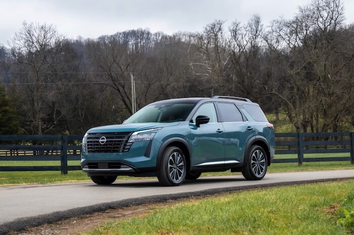 2026 Nissan Pathfinder three-row SUV driving along a country road near Murfreesboro, TN