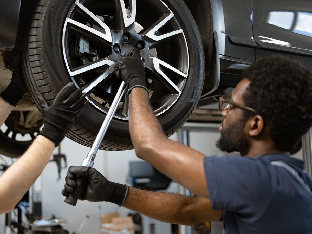 Technician completing routine wheel service on a vehicle