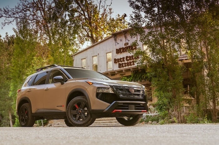 2026 Nissan Rogue Rock Creek SUV parked outside a mountain lodge