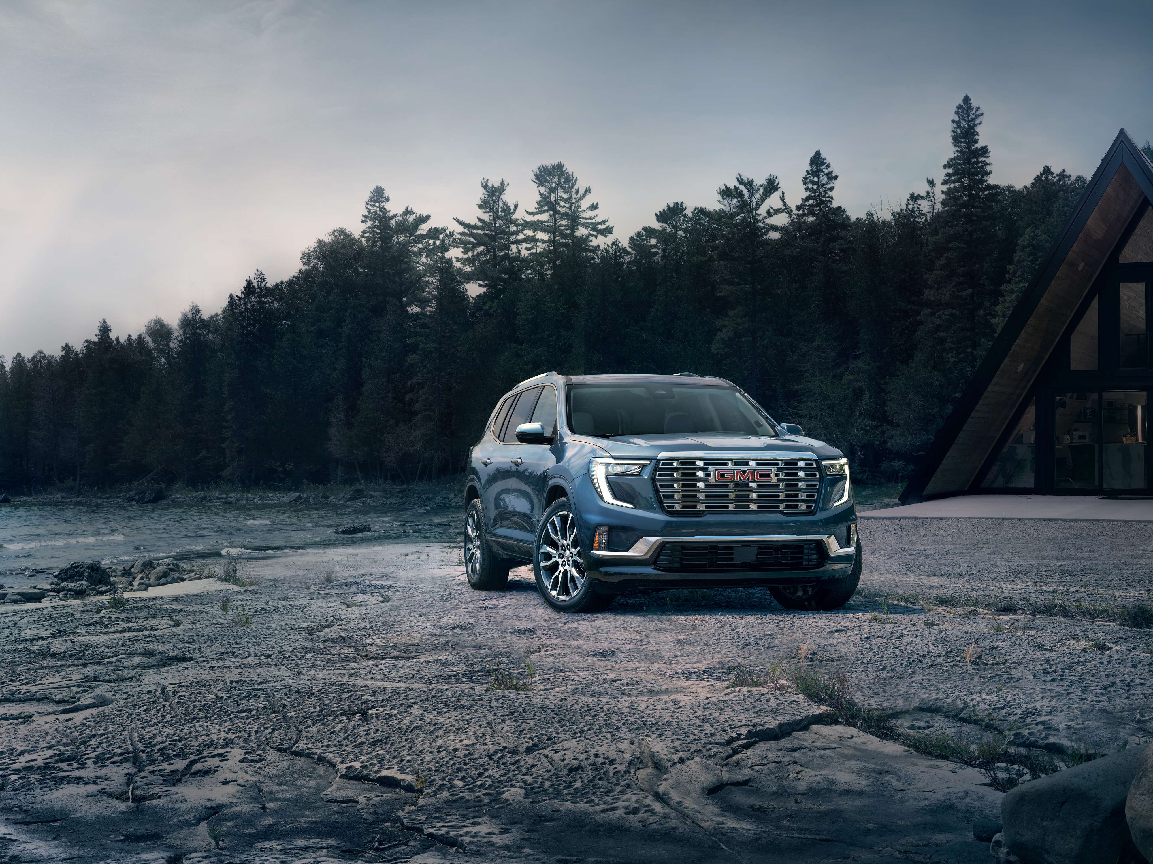 GMC Acadia Denali GMC Acadia Denali parked on a rocky shoreline