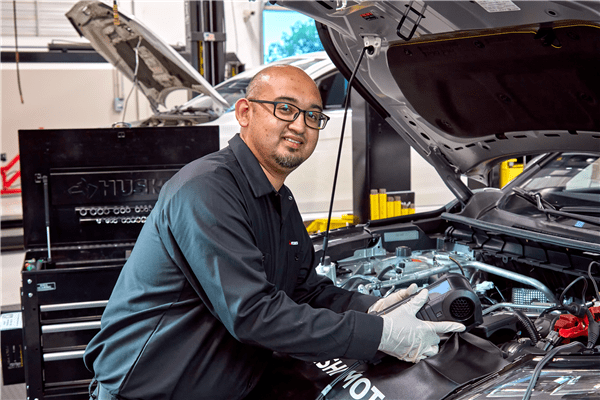 Mitsubishi technician servicing vehicle