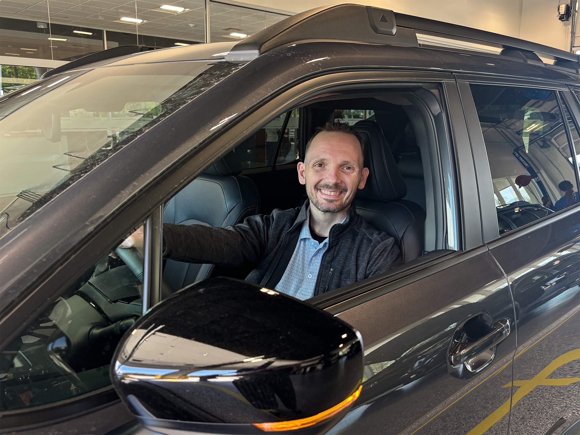 Subaru employee showing merchandise