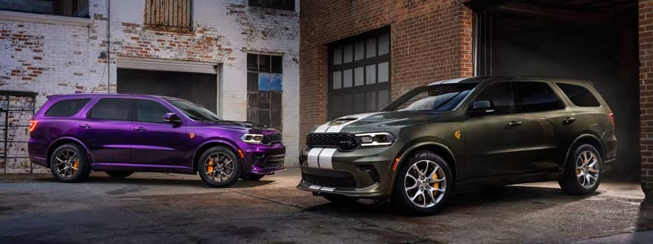 purple Dodge Durango next to green Dodge Durango