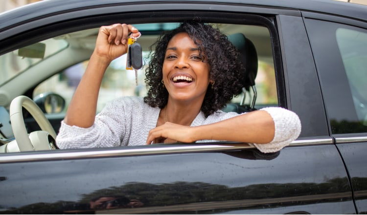 Lady displaying her keys outside the cars window