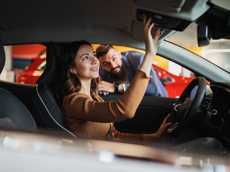 Napoli Nissan examining vehicle interior along side a sales person