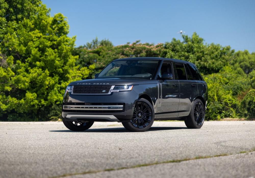 2025-land-rover-range-rover-for-sale.png Black Range Rover SUV parked on a paved lot