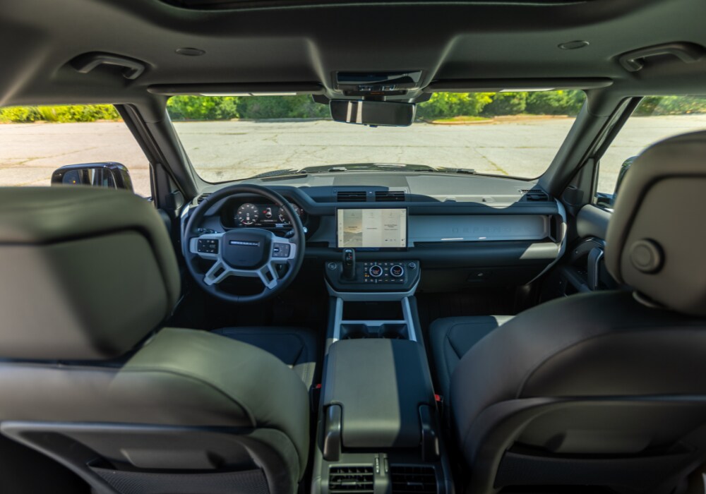 land-rover-defender-110-interior.png Shot of the Land Rover Defender 110 interior looking at the front dash and steering wheel