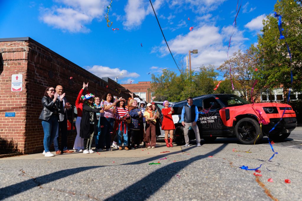 Crowd gathers in front of Bookmarks in Winston-Salem as Land Rover Greensboro delivers 2500 books