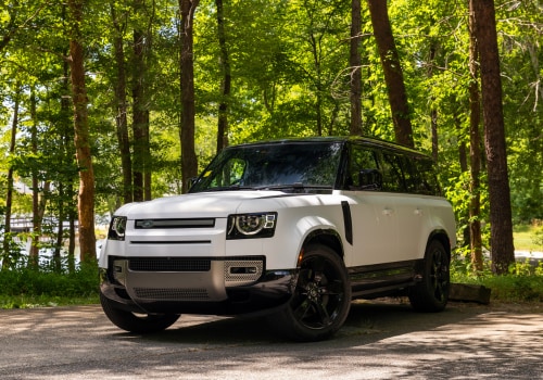 defender-130-for-sale.png White Land Rover Defender 130 SUV parked in a wooded area