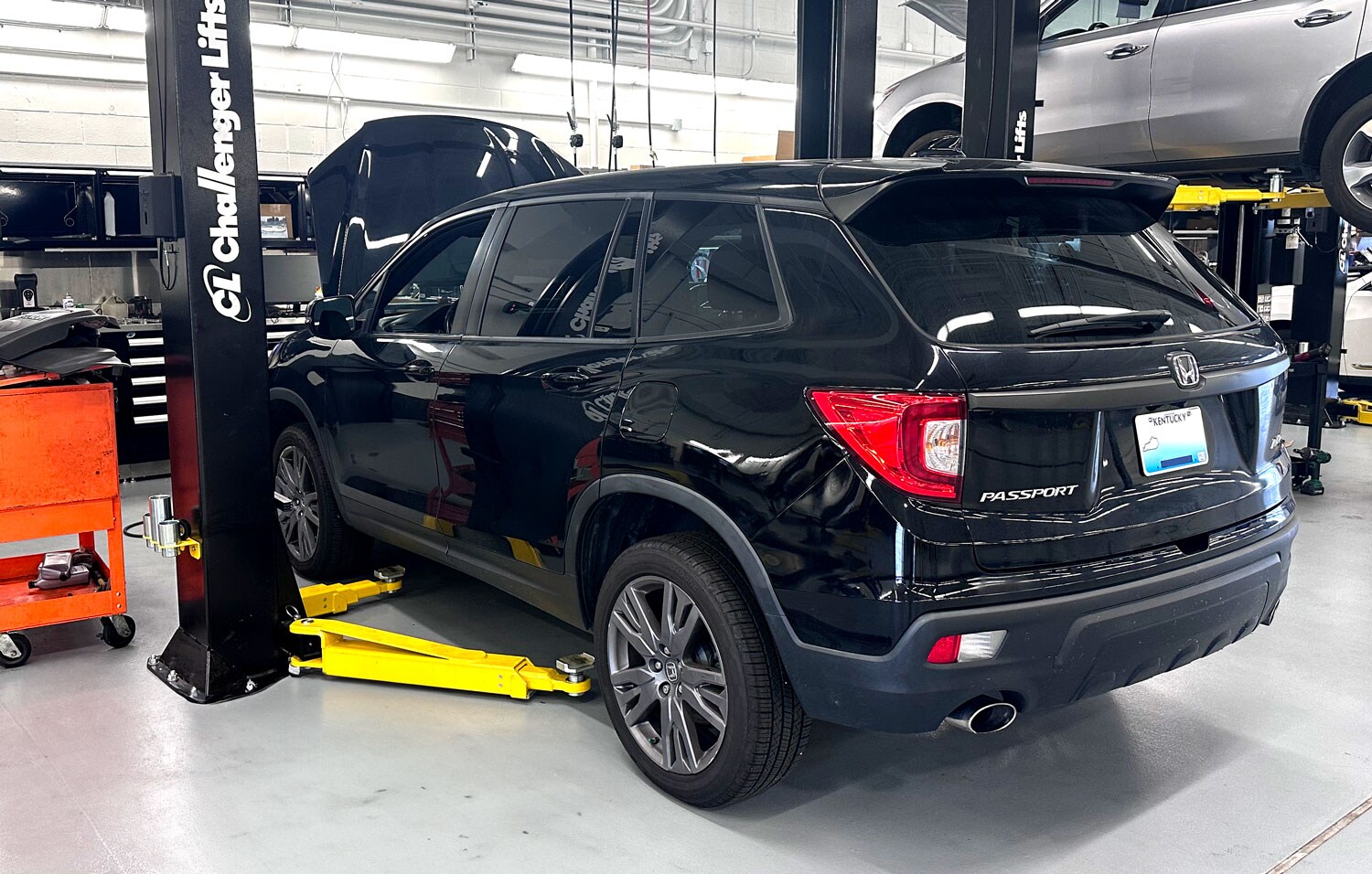 black Honda Pilot servicing at Acura dealer