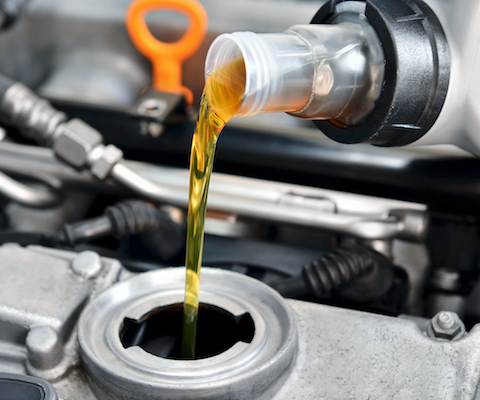 Oil pouring into a vehicle during an oil change