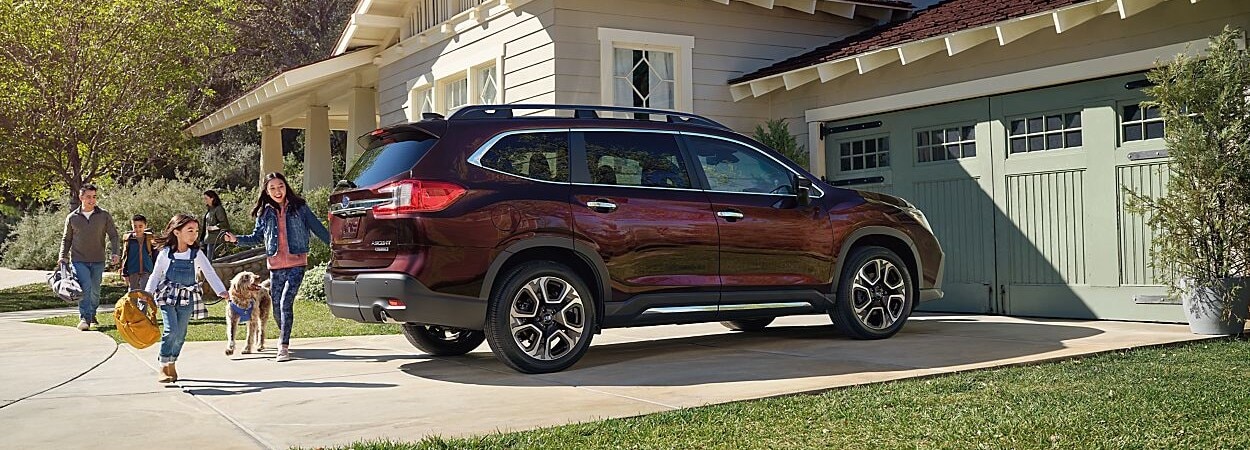 Family walking towards the KIA SUV