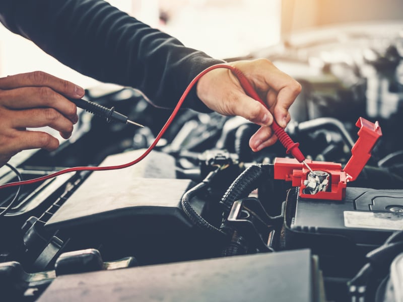 Technician testing a battery