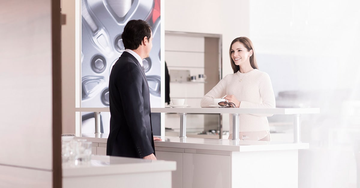 Customer speaking with salesperson at a Land Rover dealership