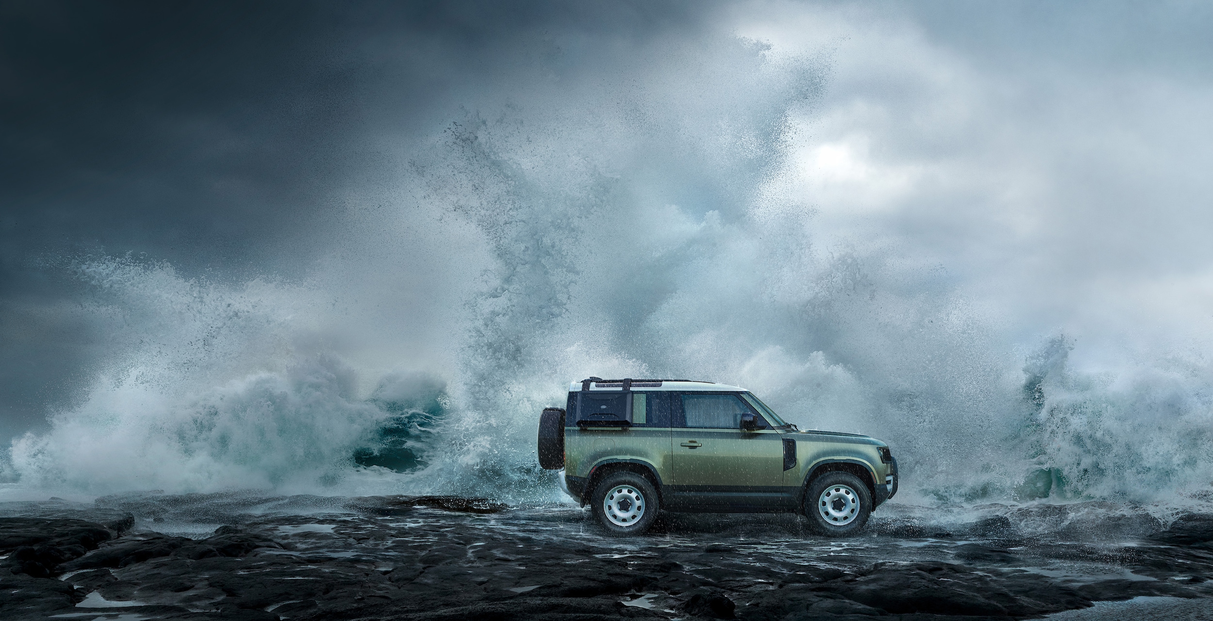 A pre-owned Land Rover model in front of crashing waves