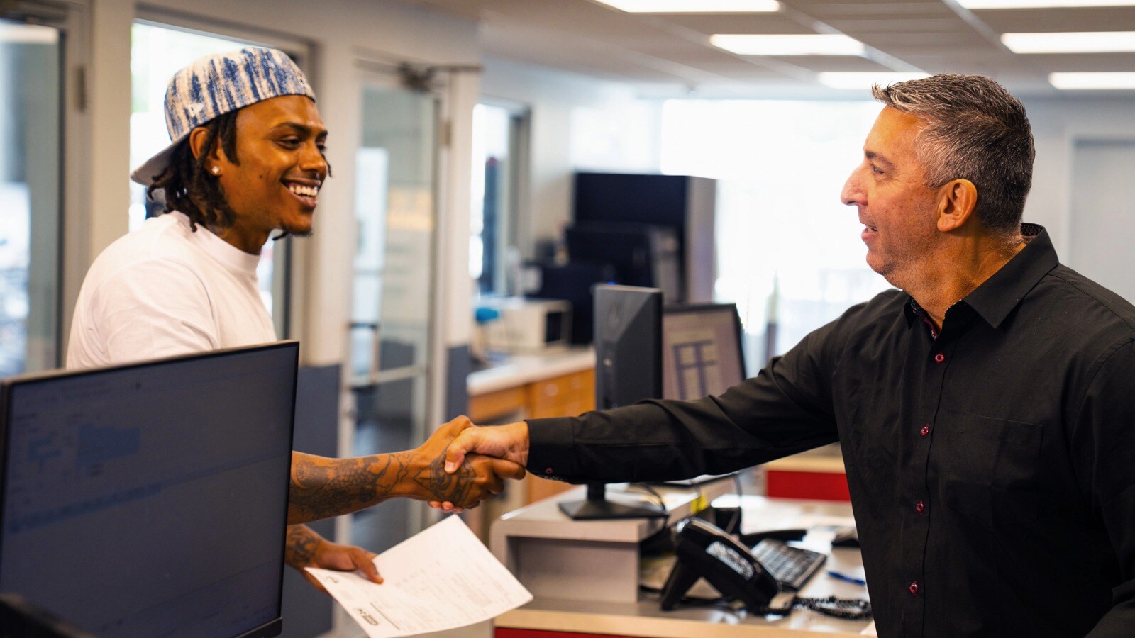 Employee Shaking Hands with Customer