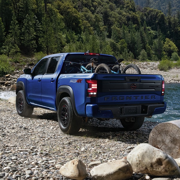 2026 Nissan Frontier parked near river with bikes