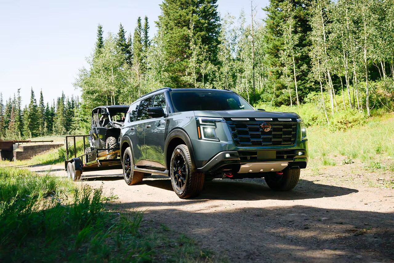 The 2026 Nissan Armada hauling a trailer with and ATV loaded on to it