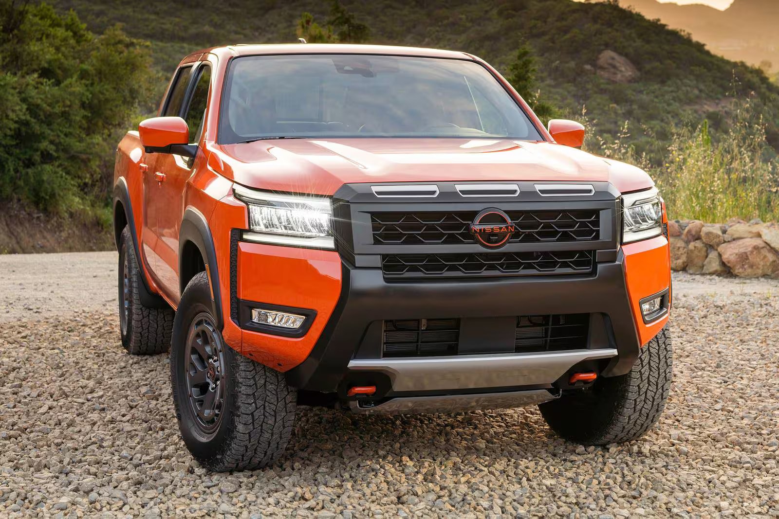 New look at the 2026 Nissan Frontier parked outside with a view of the mountains in the back ground