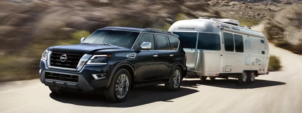 A Nissan Armada pulling a camper.