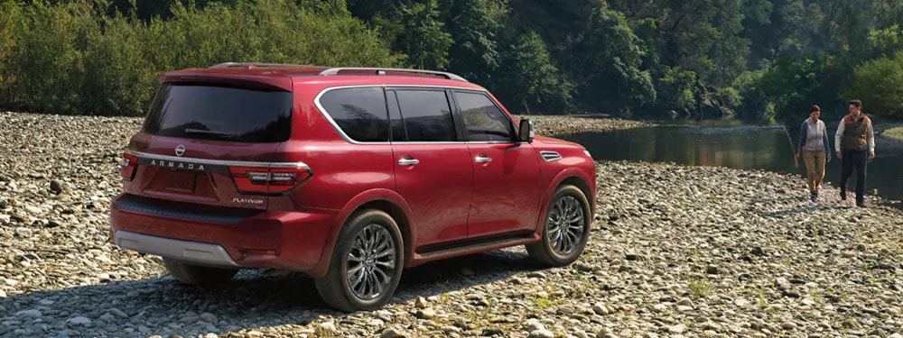 A red Nissan Armada sitting parked.