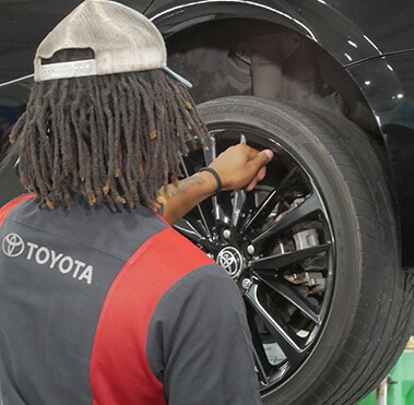 Toyota Technician working on brakes