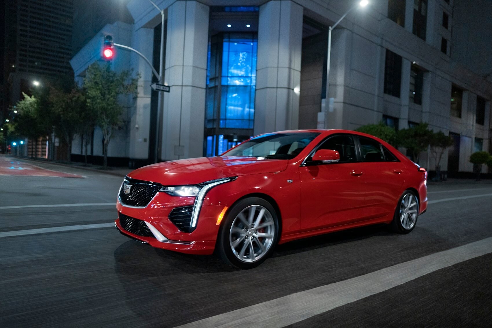 Cadillac CT5 driving through city at night - Cadillac Dealer near Me
