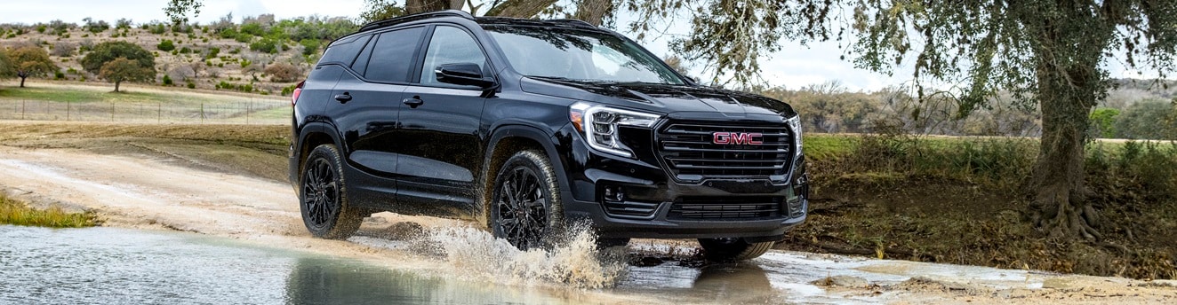 GMC Acadia Elevation driving through water on a scenic route
