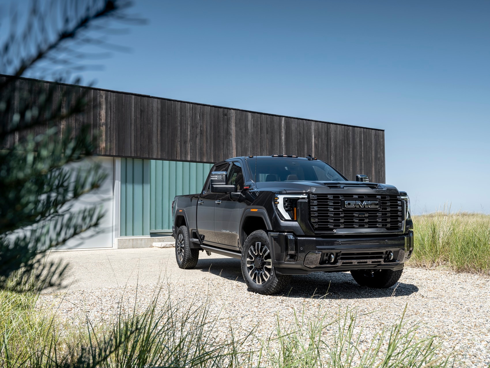 GMC Sierra 3500 HD Denali parked on the beach in front of building