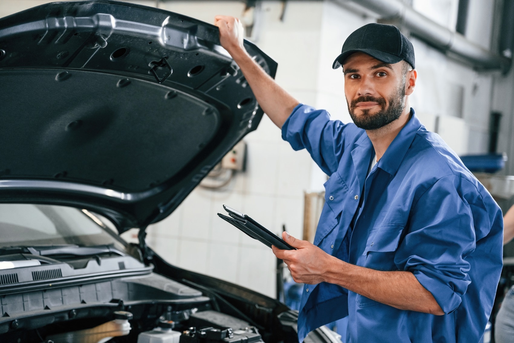 GMC Technician assessing used vehicle before servicing at Service Center Near La Mesa CA