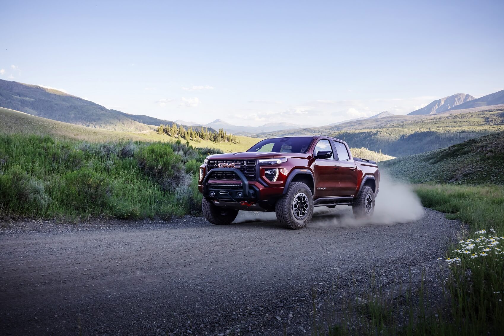 GMC Canyon driving through scenic road kicking up dirt from Used Car Dealer Near La Mesa CA
