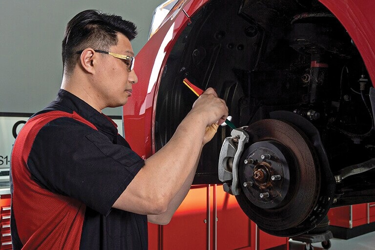 A service tech is working on a vehicle