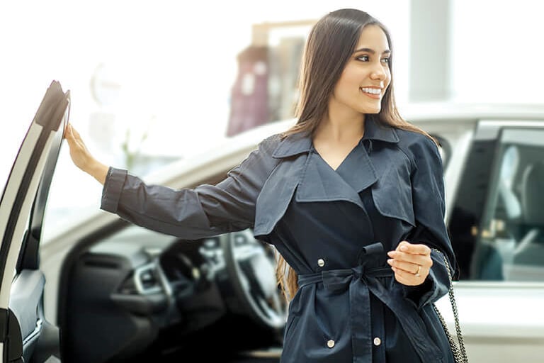 A woman walking away from a vehicle