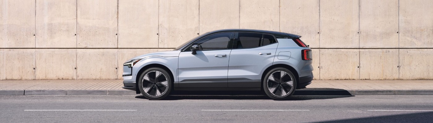 2025 Volvo EX30 SUV parked next to a sidewalk