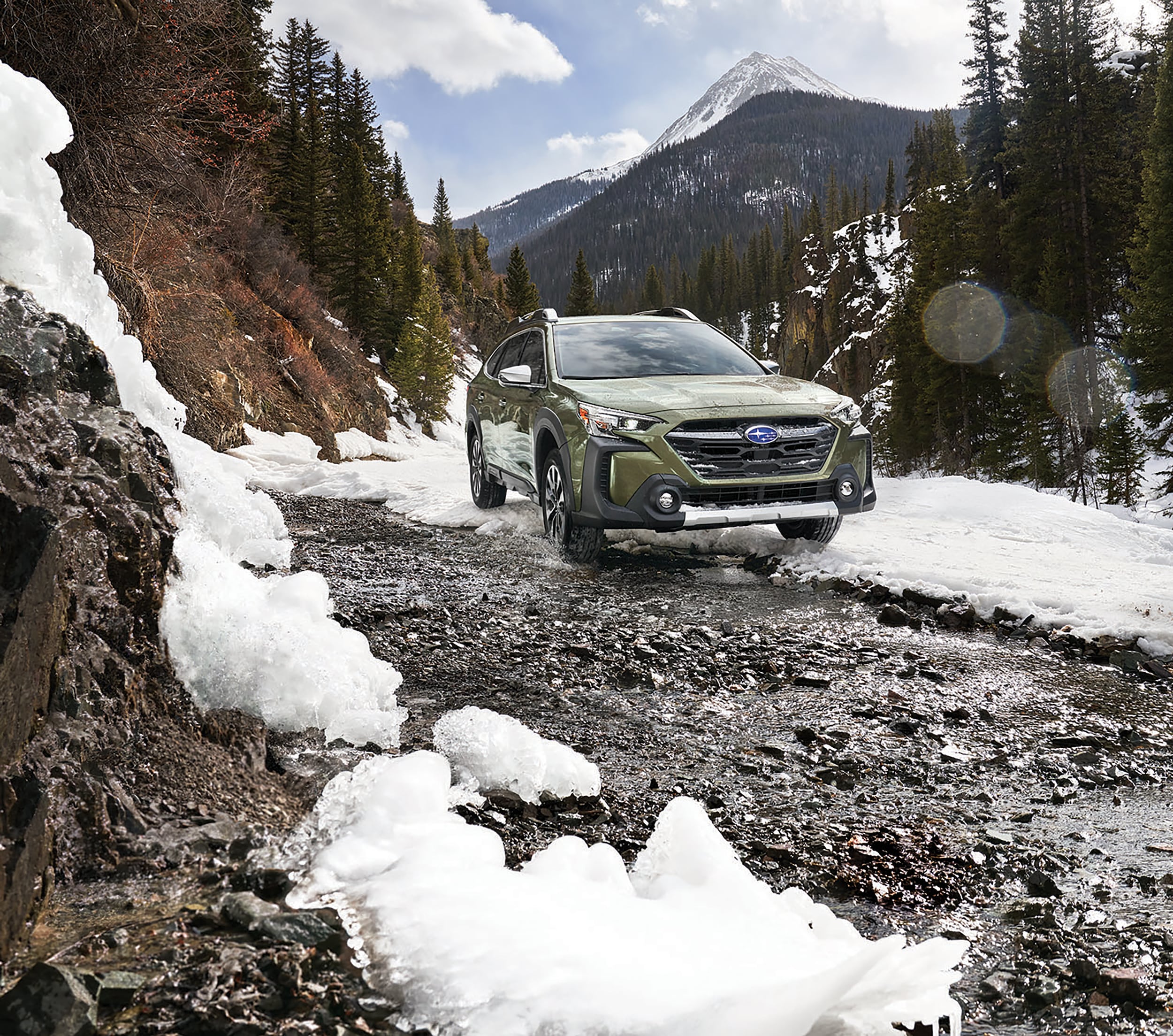 Subaru Outback on dirt road with snow