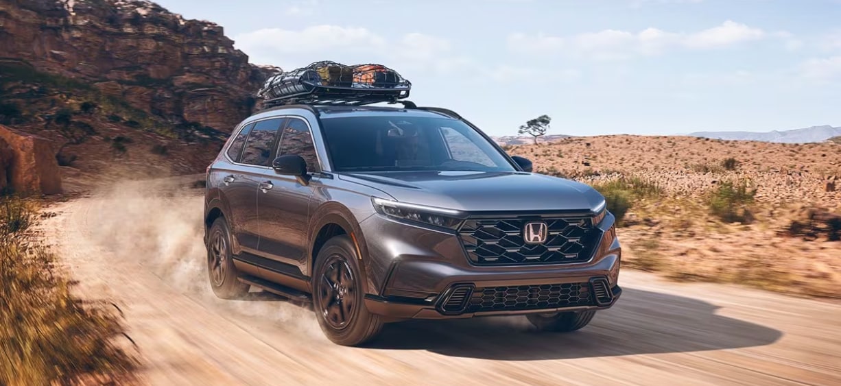 New Honda CR-V Hybrid driving on dirt path