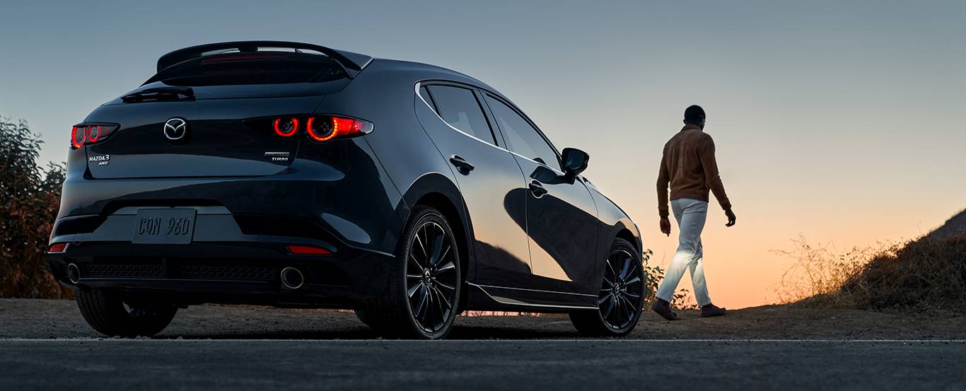 Person walking near a Mazda Certified Pre-Owned vehicle
