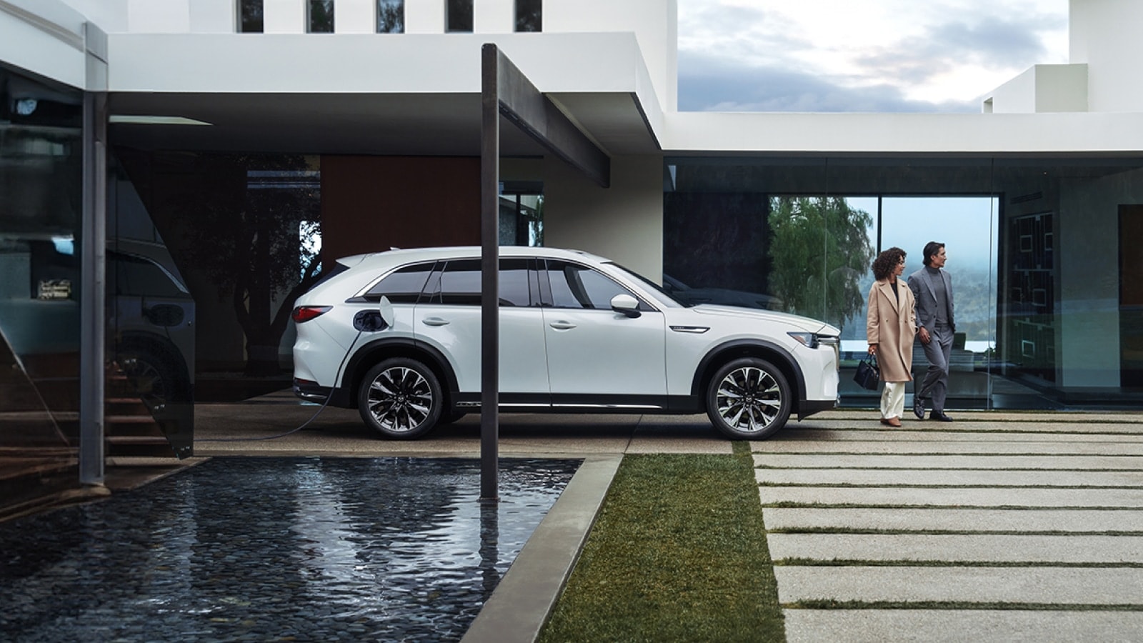 A Mazda PHEV charging in the driveway