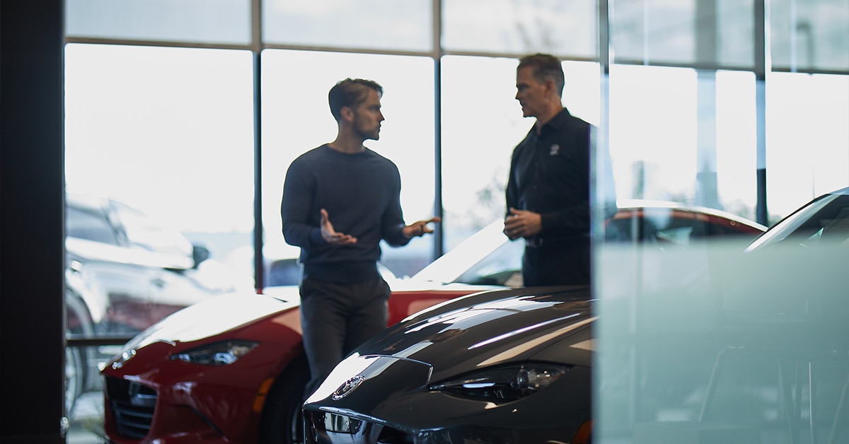 Customer speaking to salesperson about Mazda warranty transfer