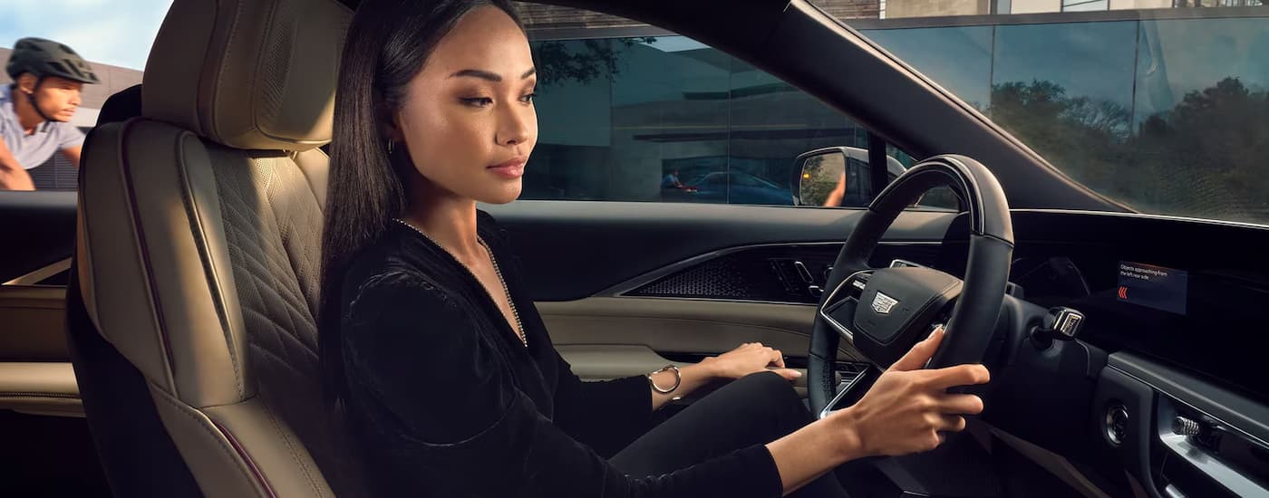 Woman test driving in a 2025 Cadillac LYRIQ for sale