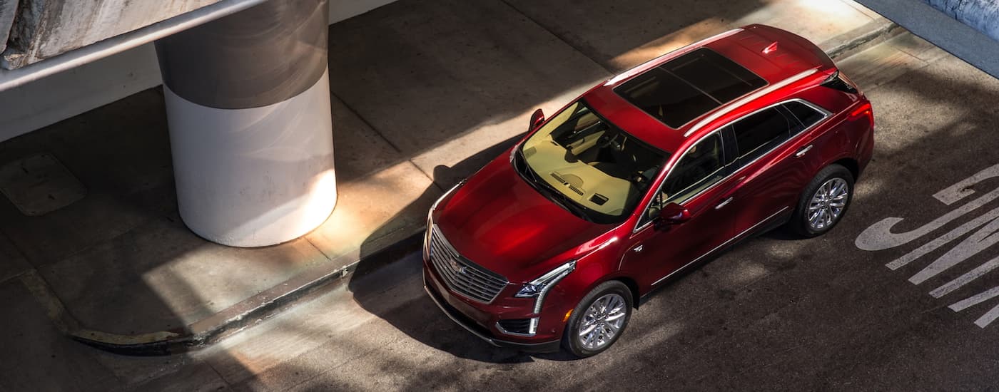Red 2017 Cadillac XT5 parked next to a concrete ramp