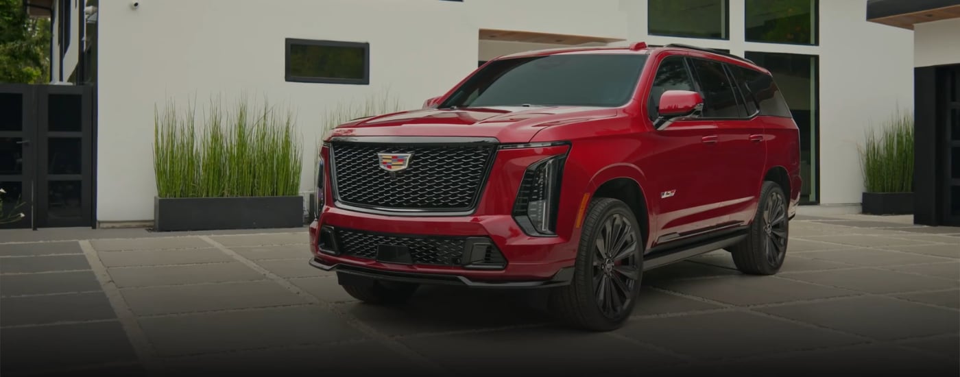 Red 2026 Cadillac Escalade V backed into a driveway