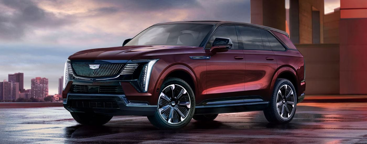 Red 2026 Cadillac Escalade IQ for sale parked outside of a dealership