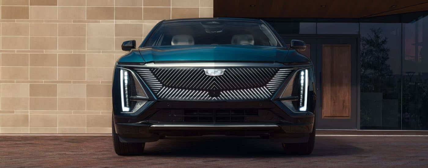 A green 2025 Cadillac LYRIQ parked in a driveway