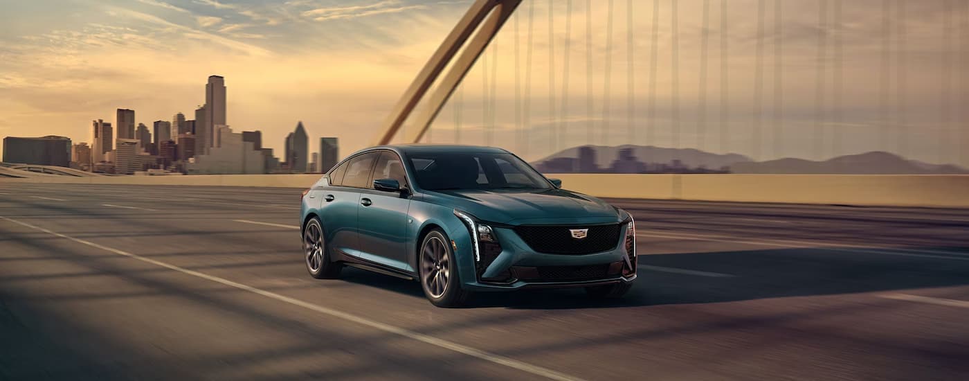 Blue 2025 Cadillac CT5 driving on a highway