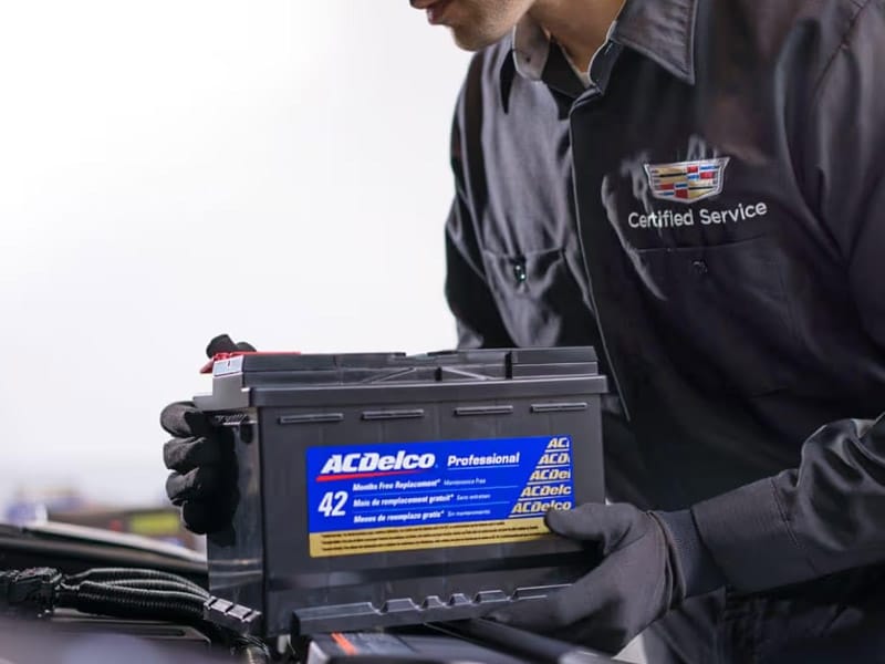 Cadillac Certified Service technician installing an ACDelco replacement battery at Ocean Cadillac in Miami