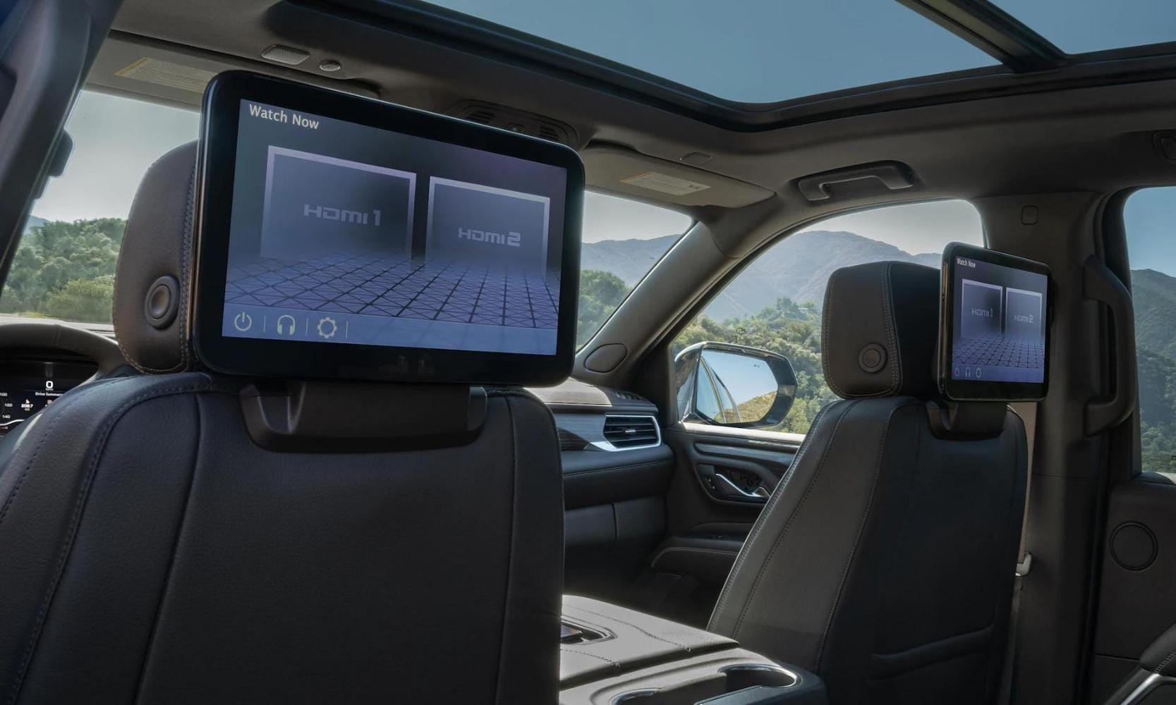 Image of the dual rear-seat media screen systems inside the 2023 GMC Yukon Denali Ultimate