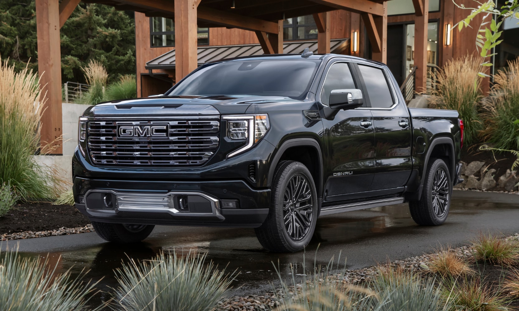 New 2022 GMC Sierra 1500 Denali Luxury Light Duty Truck - Octane Buick GMC of Santa Fe.png New 2022 GMC Sierra 1500 Denali luxury truck parked in the driveway of a nice home in the woods