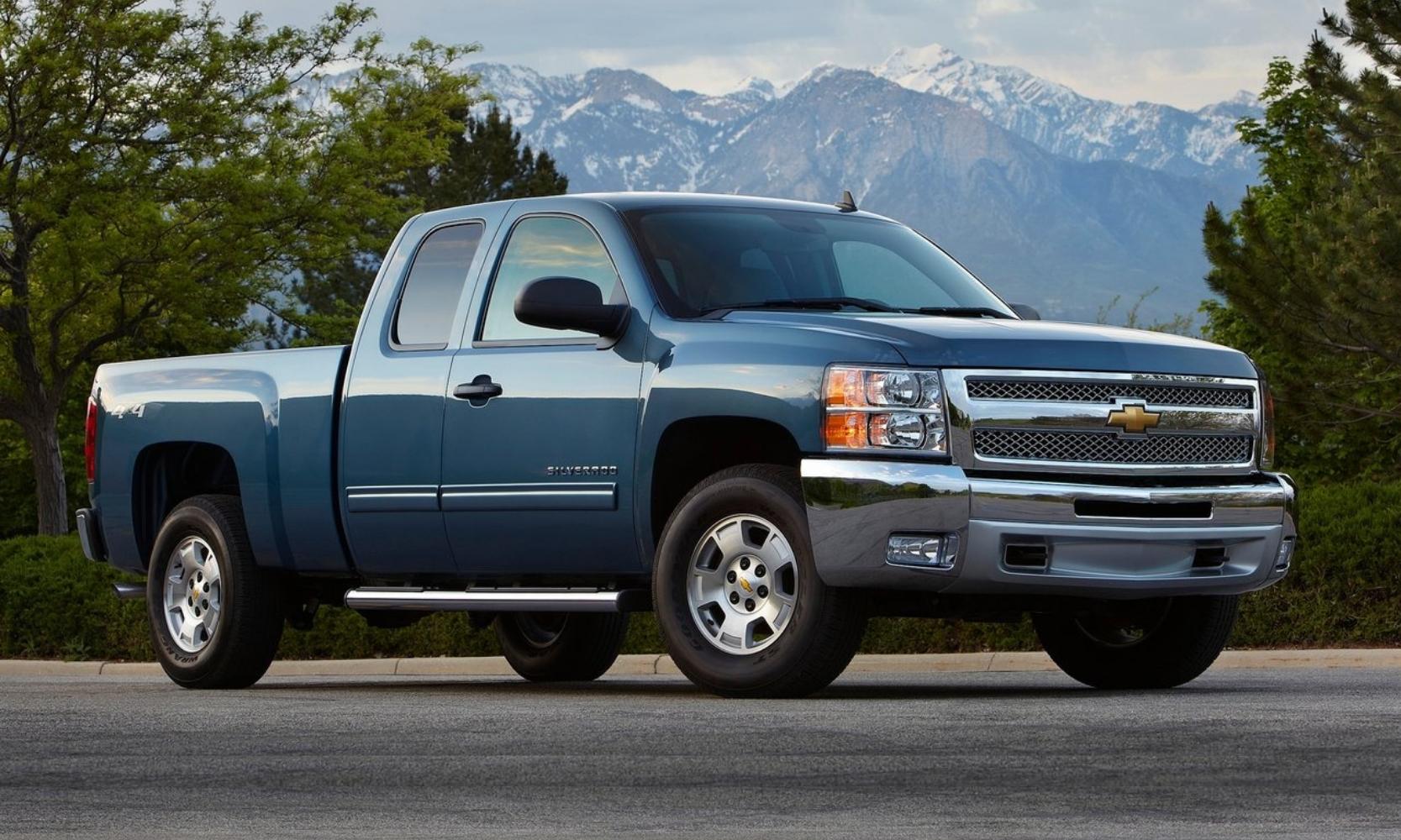 Used 2013 Chevy Silverado 1500 in steel blue exterior color with snowy mountains in the background