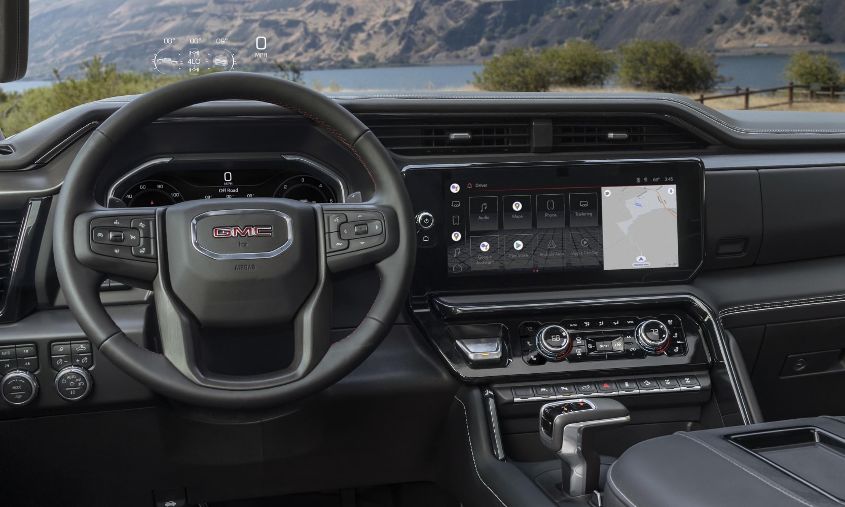 Front interior cabin inside the New 2022 GMC Sierra 1500 truck with a look at the dashboard from the driver seat
